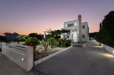 a white house with a pathway and plants at Dama Dama Villas in Gennadi