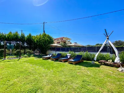 a group of lounge chairs in a yard at Rosalia House in Rhodes Town