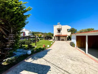 a driveway leading to a house with a tree at Rosalia House in Rhodes Town