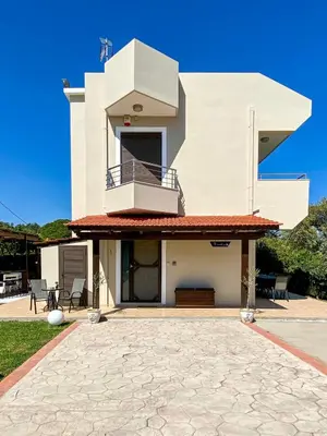 a white house with a balcony and a patio at Rosalia House in Rhodes Town