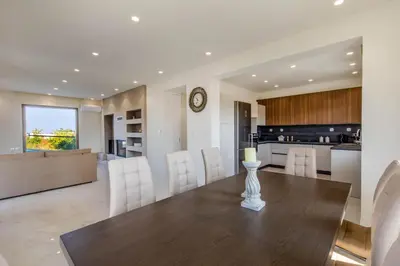 a dining room and kitchen with a table and chairs at Ktima Kritikos in Paradeísion