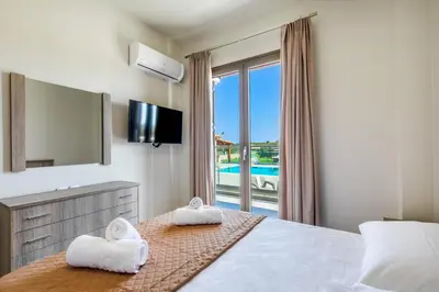 a hotel room with a bed with towels on it at Ktima Kritikos in Paradeísion