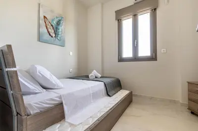 a bedroom with a bed and a window at Ktima Kritikos in Paradeísion