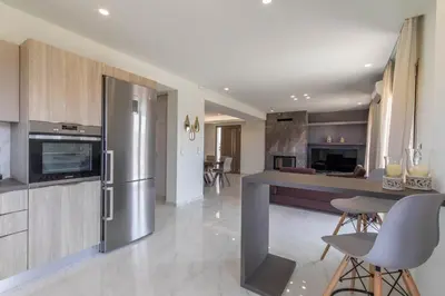 a kitchen with a stainless steel refrigerator and a counter at Ktima Kritikos in Paradeísion