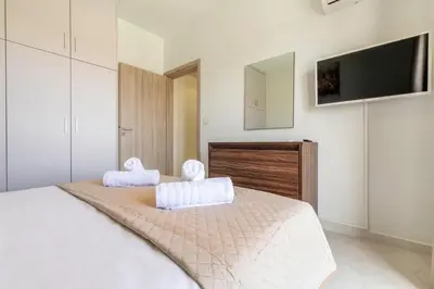 a bedroom with a bed with two towels on it at Ktima Kritikos in Paradeísion
