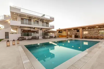 a large swimming pool in front of a building at Ktima Kritikos in Paradeísion