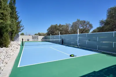 a tennis court with a tennis ball on it at Sia Mare Residence in Faliraki