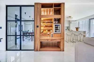 a kitchen and living room with a wooden door at Sia Mare Residence in Faliraki
