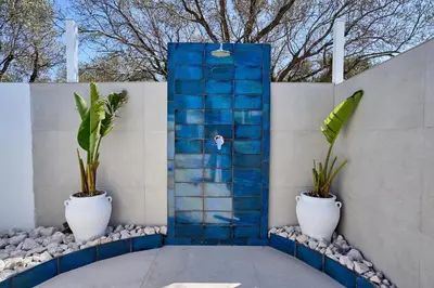 a blue tile shower with two potted plants at Sia Mare Residence in Faliraki