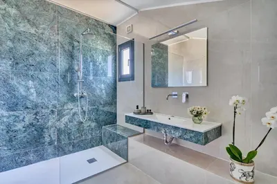 a bathroom with a sink and a shower at Sia Mare Residence in Faliraki