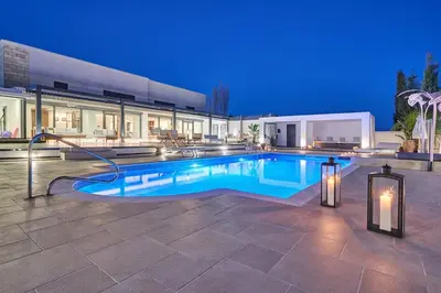 a swimming pool in front of a house at Sia Mare Residence in Faliraki