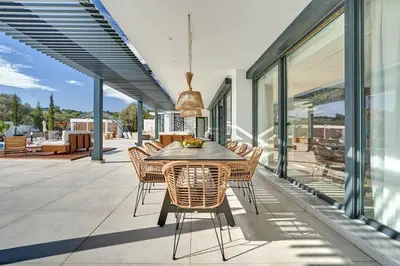 a dining area with a table and chairs on a patio at Sia Mare Residence in Faliraki