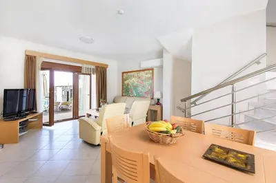 a living room with a table with a bowl of fruit on it at Holiday home in Kiotari with a terrace or balcony in Kiotari