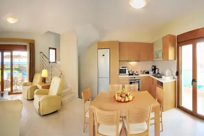 a kitchen and living room with a table and chairs at Holiday home in Kiotari with a terrace or balcony in Kiotari