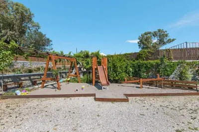 a playground with a swing set in a park at Holiday home in Kiotari with a terrace or balcony in Kiotari