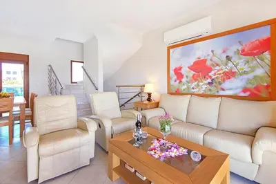 a living room with a couch and a table at Holiday home in Kiotari with a terrace or balcony in Kiotari