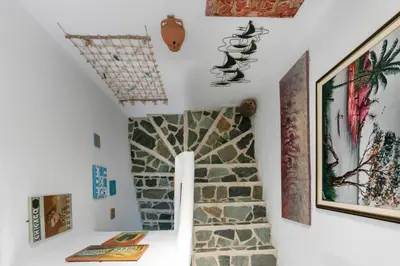 a hallway in a house with a stone wall at Nefeli house in Archangelos
