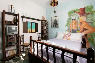 a bedroom with a bed with a painting on the wall at Nefeli house in Archangelos