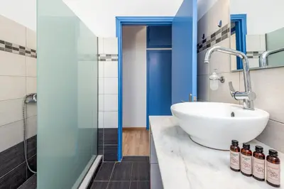 a bathroom with a sink and a shower at Rhodes Central Apartment in Rhodes Town