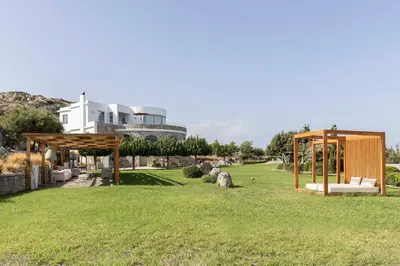 a garden with a gazebo and a building at Pristine Seaview Villa , with 5-Star Resort Access in Faliraki