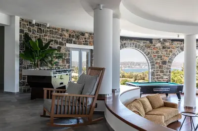 a living room with a pool table at Pristine Seaview Villa , with 5-Star Resort Access in Faliraki