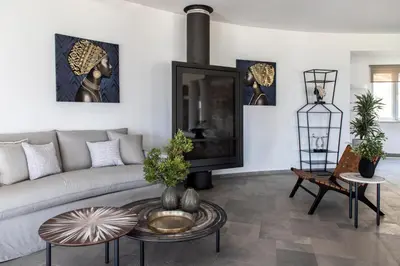 a living room with a couch and a table at Pristine Seaview Villa , with 5-Star Resort Access in Faliraki