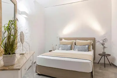 a white bedroom with a bed with two pillows at Pristine Seaview Villa , with 5-Star Resort Access in Faliraki
