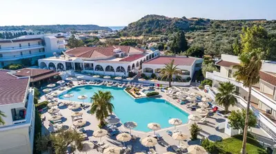 an aerial view of a resort with a pool and umbrellas at Niriides Hotel in Kolimbia