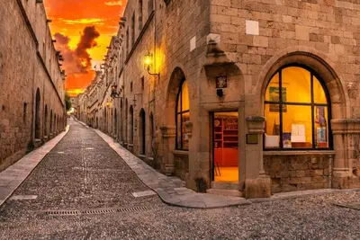 an empty street in an old building with a sunset at Emerald Dream House#Poiessa, Medieval Town in Rhodes Town