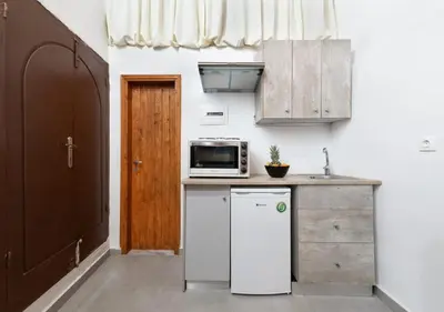 a kitchen with a white refrigerator and a microwave at Emerald Dream House#Poiessa, Medieval Town in Rhodes Town