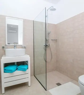 a bathroom with a shower and a sink and a toilet at La Residenzia in Kalithies