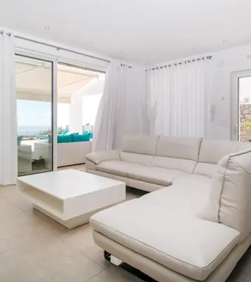 a living room with a white couch and a table at La Residenzia in Kalithies