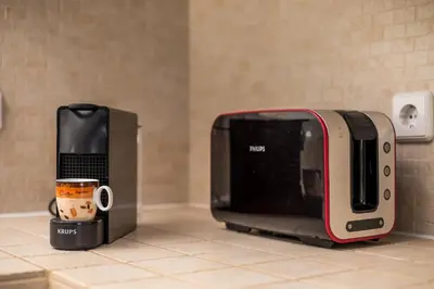 a microwave sitting on a counter next to a cup of coffee at Afandou Sea View in Afantou