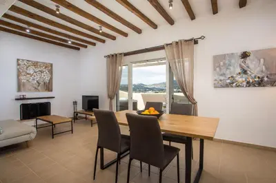 a living room with a wooden table and chairs at Afandou Sea View in Afantou