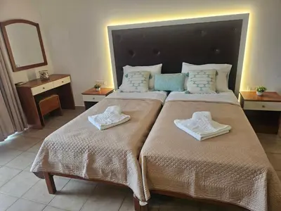 a bedroom with two beds with towels on them at Apollonio Rooms Faliraki Rhodes in Faliraki