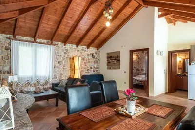 a living room with a couch and a table at Filerolia Stone House in Pastida