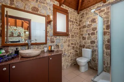 a bathroom with a sink and a toilet at Filerolia Stone House in Pastida