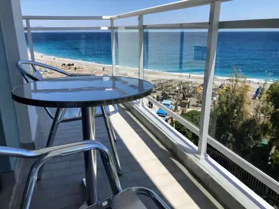a balcony with a table and a view of the beach at Amalia Sea Hotel in Rhodes Town