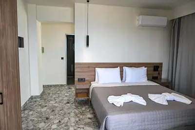 a bedroom with a bed with towels on it at Amalia Sea Hotel in Rhodes Town