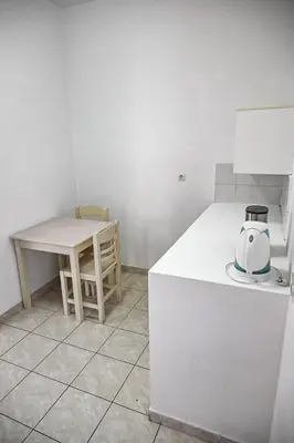 a kitchen with a table and a appliance on a counter at Amalia Sea Hotel in Rhodes Town