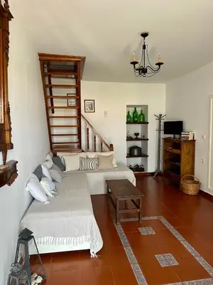 a living room with a couch and a table at Constantia in Symi