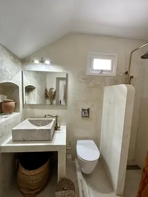 a bathroom with a sink and a toilet at Constantia in Symi