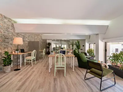 a living room with tables and chairs at STAY Rhodes Hotel in Rhodes Town