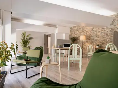 a living room with green chairs and a table at STAY Rhodes Hotel in Rhodes Town