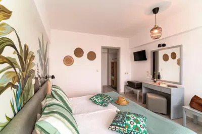a living room with a white couch and a sink at STAY Rhodes Hotel in Rhodes Town