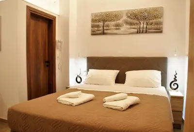 a bedroom with a bed with two towels on it at Evangelia's Little House in Rhodes Town