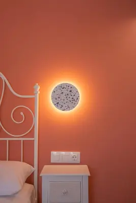 a bedroom with a bed with a light on the wall at Oliveto A Flumine - Experientia Villa in Pastida