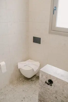 a white toilet in a bathroom with a window at Oliveto A Flumine - Experientia Villa in Pastida