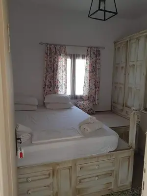 a bedroom with a large bed with a window at Soultana studios in Líndos