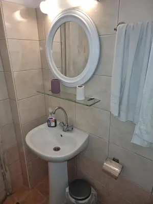 a bathroom with a sink and a mirror at Soultana studios in Líndos